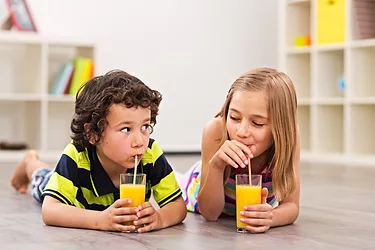Boy-and-Girl-Drinking-Orange-Juice.jpg Boy and girl drinking orange juice