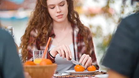 Woman slicing tomato