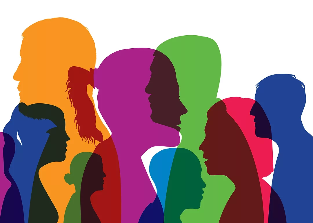 Concept of a cosmopolitan population with different silhouettes of men's and women's heads in colors and profile views.