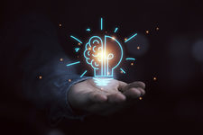 Hand holding drawing virtual lightbulb with brain on bokeh background for creative thinking idea and innovation concept.