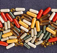 heap of pills close-up. vitamin dietary supplements on on burlap rag. immune prevention care concept