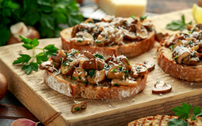 Grilled mushroom toast with parsley, lemon and parmesan cheese on wooden board. healthy vegan food.