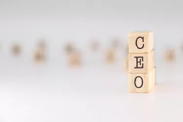 Acronym CEO written on wooden cubes isolated on white background. Concept text for chief executive officer