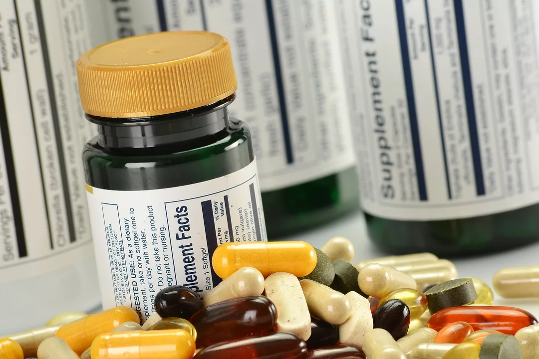 Composition with dietary supplement capsules and containers. Variety of pills