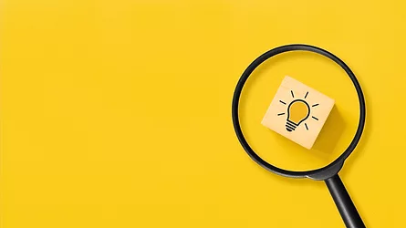 Creative idea concept, magnifying glass and light bulb icon on wooden block with yellow background