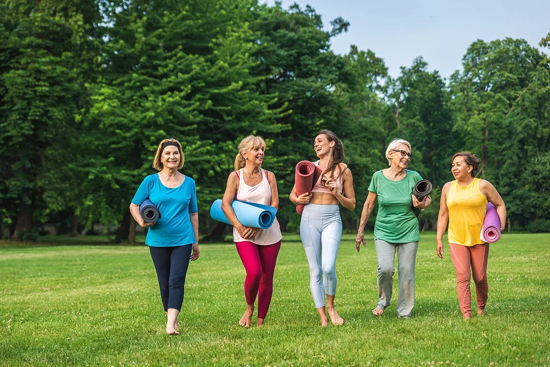 Multiethnic group of women exercising at a park.