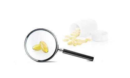 Supplements shown under a magnifying glass, symbolizing increased scrutiny of regulatory oversight and product transparency in the dietary supplement marketplace.