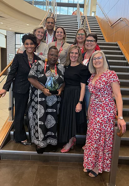 Mary Ann Nation-Greenwall encircled by WIN members, holding 2026 WIN Heroine Award.