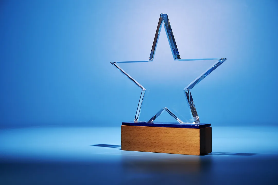 Crystal star shape trophy against blue background